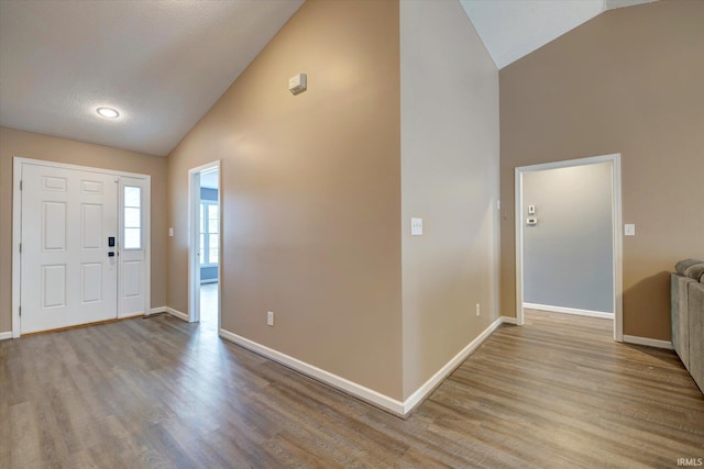 1063 S Colchester Ct, Bloomington, IN 47401 - foyer entrance with high vaulted ceiling, wood finished floors, and baseboards