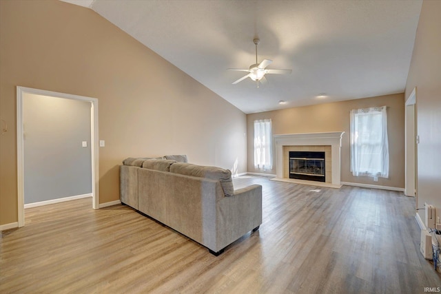 1063 S Colchester Ct, Bloomington, IN 47401 - living area featuring ceiling fan, light wood finished floors, baseboards, and high vaulted ceiling