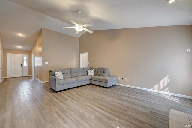 1063 S Colchester Ct, Bloomington, IN 47401 - living area featuring baseboards, ceiling fan, wood finished floors, and lofted ceiling