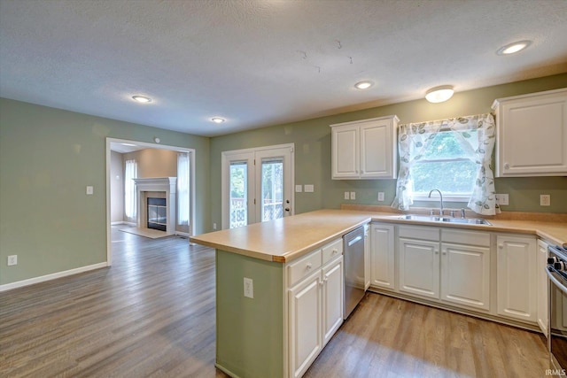 1063 S Colchester Ct, Bloomington, IN 47401 - kitchen with a sink, appliances with stainless steel finishes, light wood-style floors, a peninsula, and recessed lighting