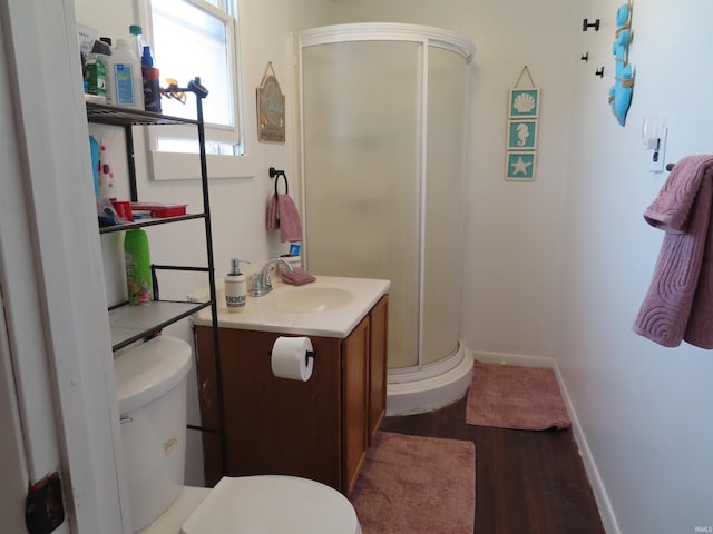 303 S Lenfesty Ave, Marion, IN 46952 - bathroom featuring a stall shower, toilet, vanity, wood finished floors, and baseboards