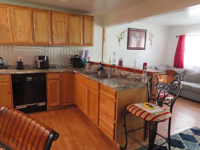 303 S Lenfesty Ave, Marion, IN 46952 - kitchen with black dishwasher, a sink, light wood-style floors, tasteful backsplash, and open floor plan