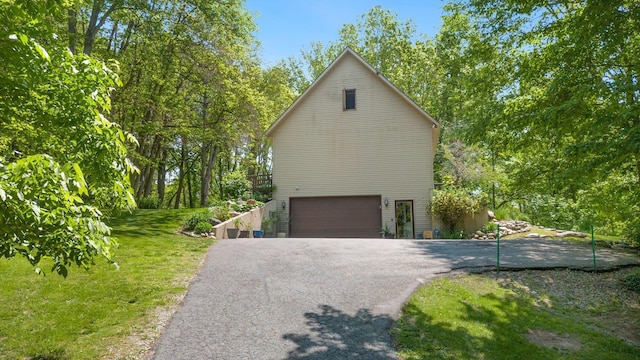 2796 N 85 W, Angola, IN 46703 - view of side of property featuring a garage, driveway, and a lawn