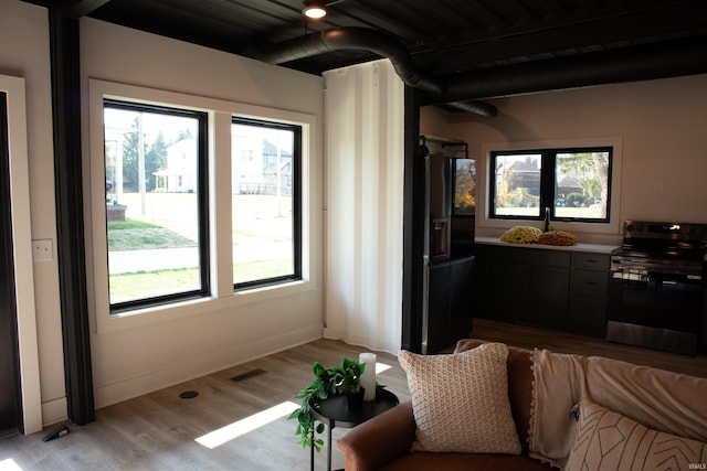 904 E Berry St, Fort Wayne, IN 46803 - living area featuring light wood-style flooring and baseboards