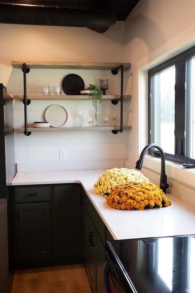 904 E Berry St, Fort Wayne, IN 46803 - kitchen featuring open shelves, light countertops, wood finished floors, and electric range oven