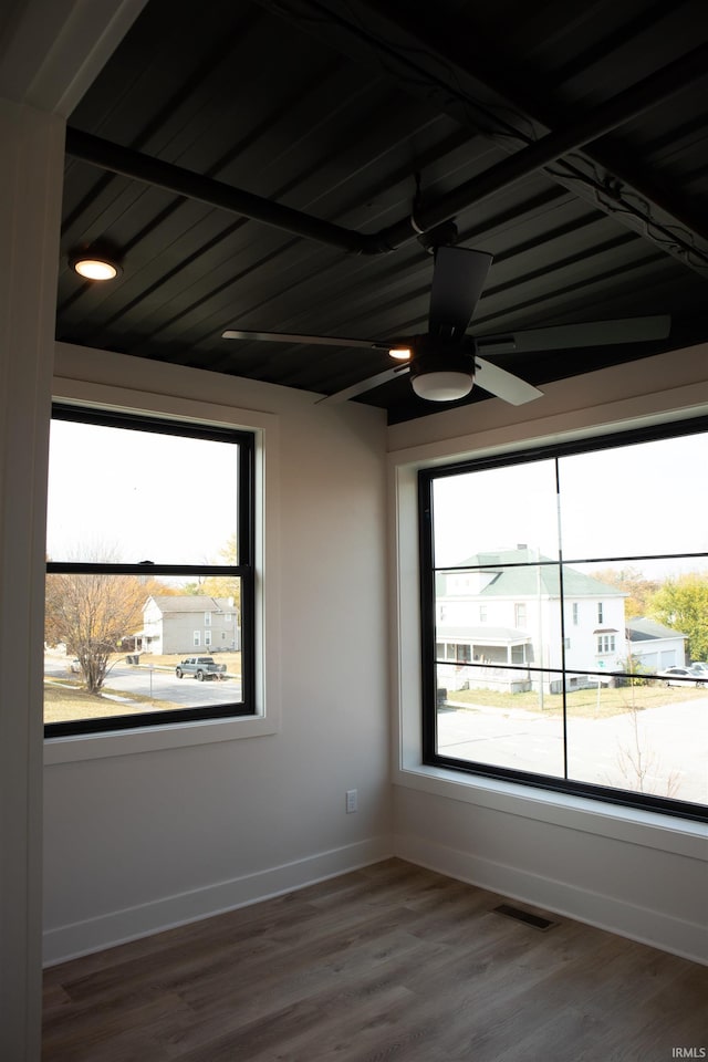 904 E Berry St, Fort Wayne, IN 46803 - empty room with plenty of natural light, ceiling fan, baseboards, and wood finished floors