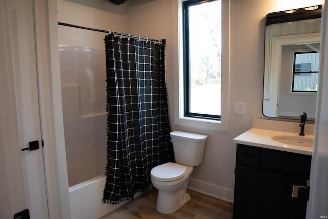 904 E Berry St, Fort Wayne, IN 46803 - bathroom with vanity, toilet, baseboards, wood finished floors, and shower / bathtub combination with curtain