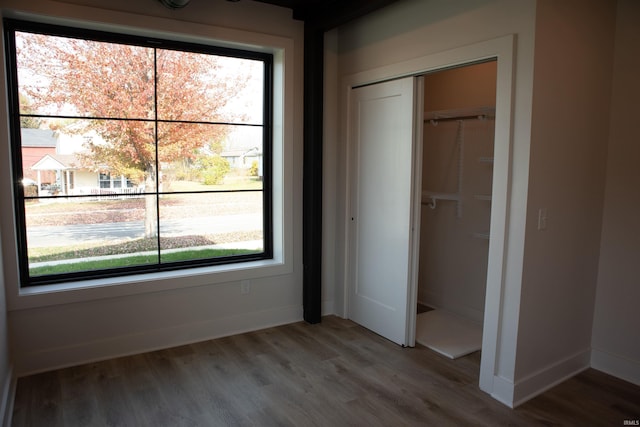 904 E Berry St, Fort Wayne, IN 46803 - unfurnished bedroom featuring a closet, wood finished floors, and baseboards