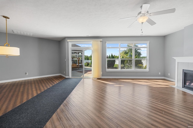 1380 Solemar Dr, West Lafayette, IN 47906 - unfurnished living room with wood finished floors, a fireplace, baseboards, and a ceiling fan