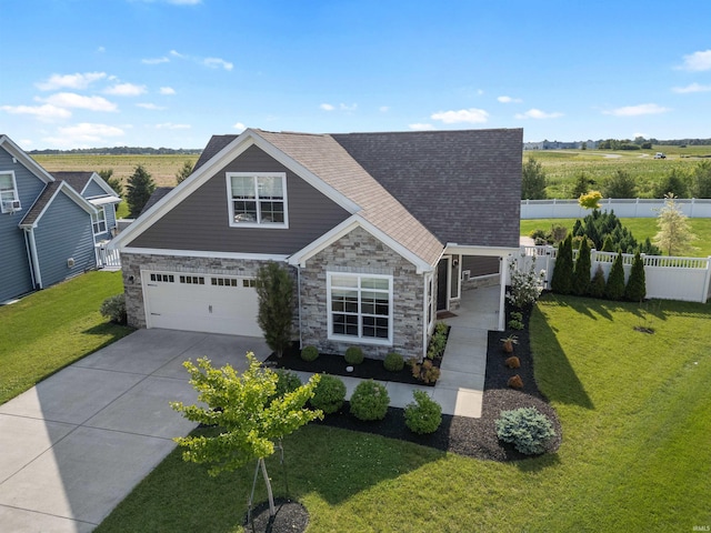 1380 Solemar Dr, West Lafayette, IN 47906 - view of front of home featuring stone siding, driveway, an attached garage, and a shingled roof