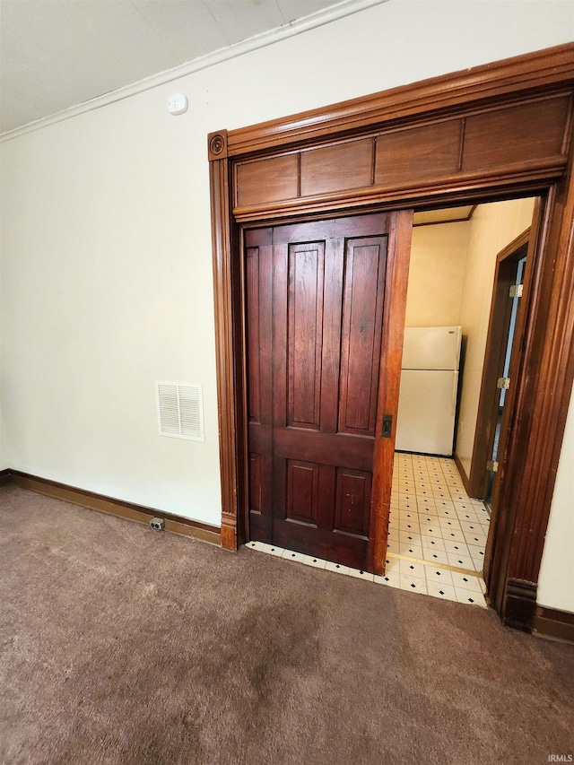 708 Columbia Ave, Fort Wayne, IN 46805 - foyer featuring crown molding, baseboards, and light carpet