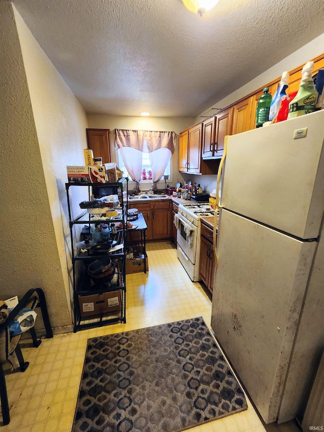 708 Columbia Ave, Fort Wayne, IN 46805 - kitchen with white appliances, light flooring, a textured ceiling, and brown cabinets