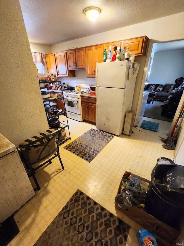 708 Columbia Ave, Fort Wayne, IN 46805 - kitchen with white appliances, a textured ceiling, brown cabinets, and light floors