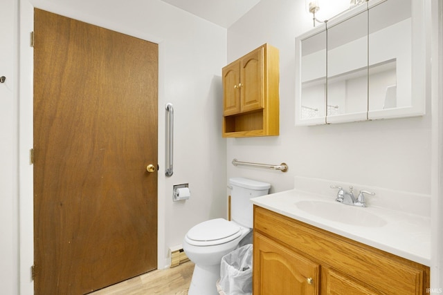1210 Mcintyre Dr, Auburn, IN 46706 - bathroom featuring toilet, vanity, and wood finished floors