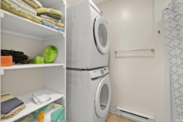 1210 Mcintyre Dr, Auburn, IN 46706 - washroom with a baseboard heating unit, stacked washing machine and dryer, and wood finished floors
