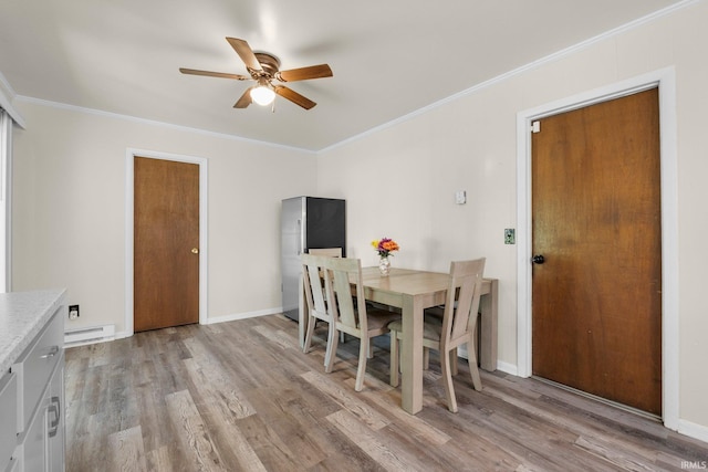 1210 Mcintyre Dr, Auburn, IN 46706 - dining room with light wood-type flooring, ceiling fan, baseboard heating, ornamental molding, and baseboards