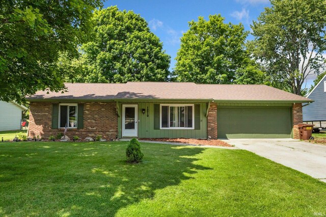 1210 Mcintyre Dr, Auburn, IN 46706 - single story home with a garage, concrete driveway, a front lawn, brick siding, and board and batten siding