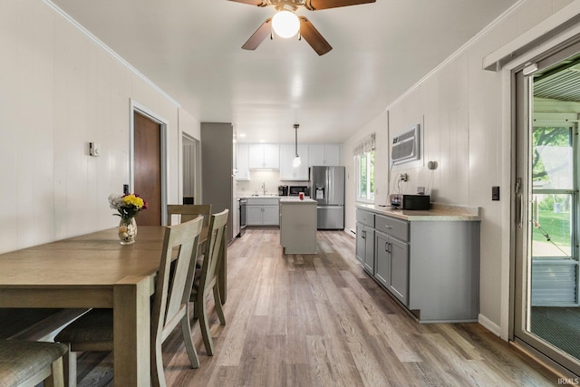 1210 Mcintyre Dr, Auburn, IN 46706 - kitchen featuring stainless steel fridge, gray cabinets, a sink, light wood-type flooring, and a center island