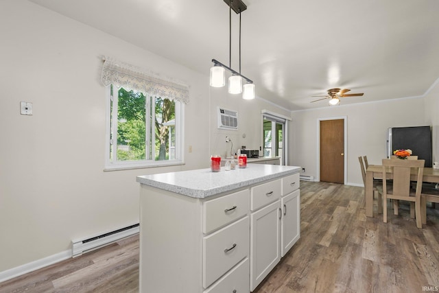 1210 Mcintyre Dr, Auburn, IN 46706 - kitchen featuring a baseboard heating unit, white cabinets, ceiling fan, light countertops, and wood finished floors