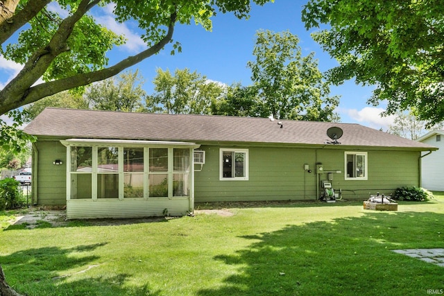 1210 Mcintyre Dr, Auburn, IN 46706 - rear view of house featuring a lawn, roof with shingles, and a sunroom