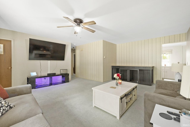 1210 Mcintyre Dr, Auburn, IN 46706 - living room with a ceiling fan, light carpet, a fireplace, and wallpapered walls