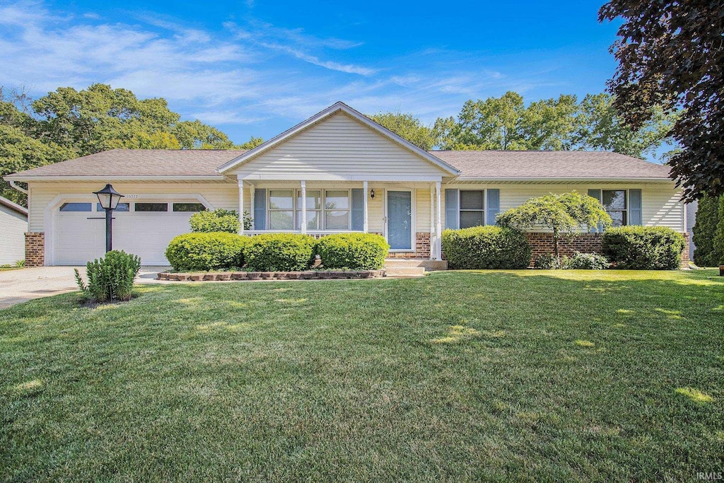 10377 Pleasant Valley Ct, Osceola, IN 46561 - ranch-style home with a garage, a front lawn, driveway, brick siding, and a shingled roof