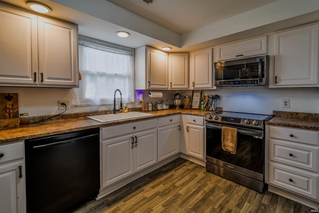 407 S Colony Dr, Garrett, IN 46738 - kitchen featuring stainless steel appliances, a sink, white cabinets, and dark wood finished floors