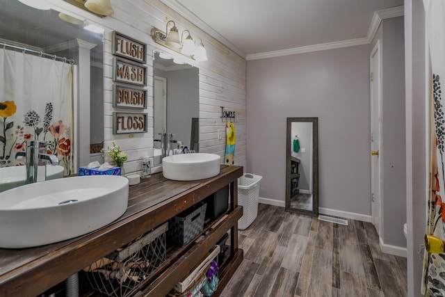 407 S Colony Dr, Garrett, IN 46738 - bathroom with crown molding, double vanity, wood finished floors, wood walls, and baseboards