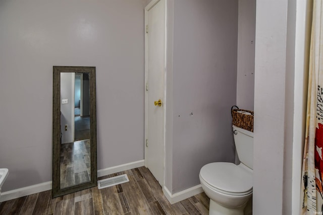 407 S Colony Dr, Garrett, IN 46738 - bathroom featuring wood finished floors, toilet, and baseboards