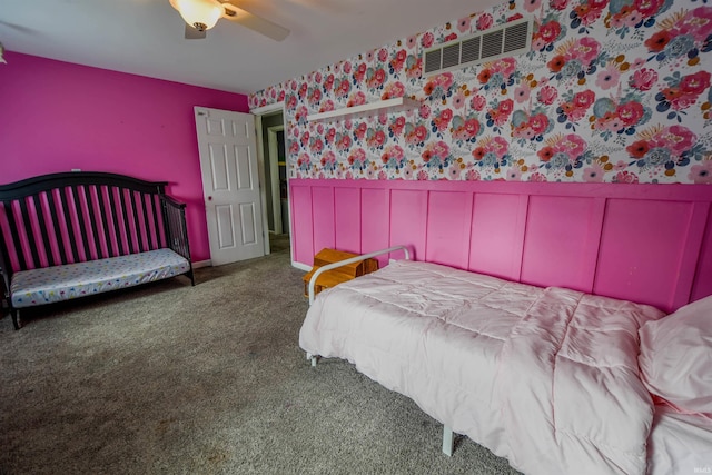407 S Colony Dr, Garrett, IN 46738 - carpeted bedroom featuring wainscoting, wallpapered walls, a ceiling fan, and a decorative wall