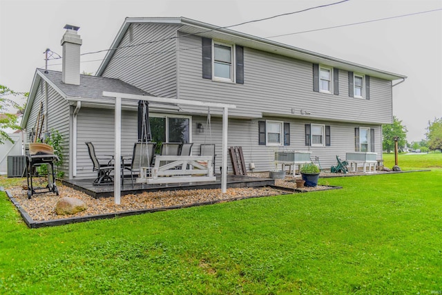 407 S Colony Dr, Garrett, IN 46738 - rear view of house featuring a chimney, a yard, and a deck