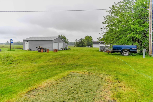 407 S Colony Dr, Garrett, IN 46738 - view of green lawn featuring a garage and an outbuilding
