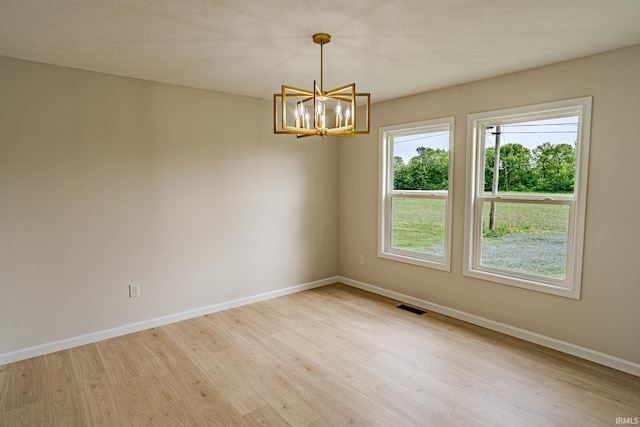 2135 Old Oak Dr, West Lafayette, IN 47906 - unfurnished room featuring a chandelier, wood finished floors, healthy amount of natural light, and baseboards