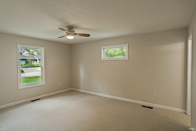 2135 Old Oak Dr, West Lafayette, IN 47906 - unfurnished room featuring healthy amount of natural light, a ceiling fan, light colored carpet, and baseboards