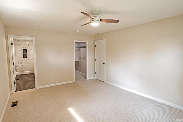 2135 Old Oak Dr, West Lafayette, IN 47906 - unfurnished bedroom with carpet, baseboards, a closet, a spacious closet, and a ceiling fan