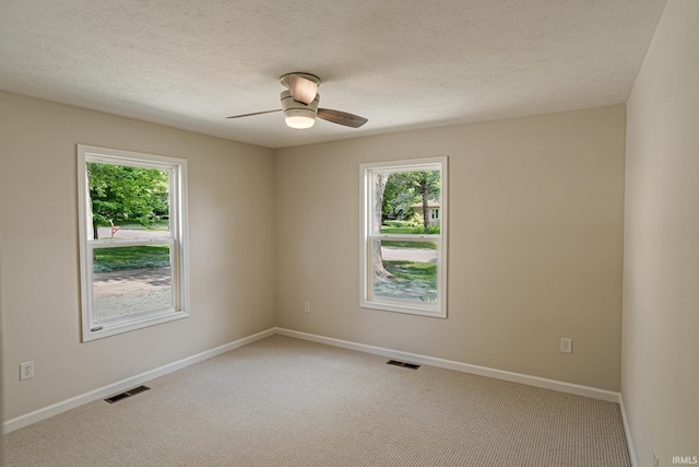 2135 Old Oak Dr, West Lafayette, IN 47906 - empty room featuring healthy amount of natural light, light carpet, ceiling fan, and a textured ceiling