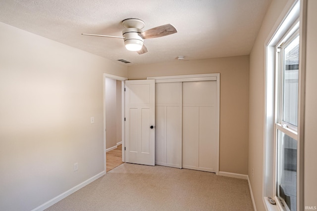 2135 Old Oak Dr, West Lafayette, IN 47906 - unfurnished bedroom featuring light carpet, baseboards, a closet, and ceiling fan