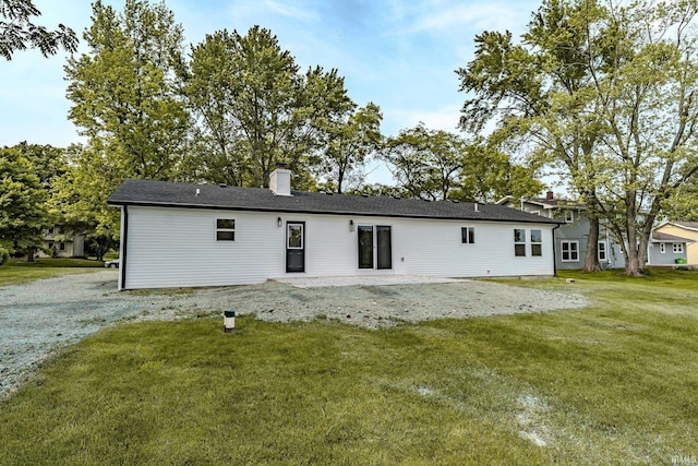 2135 Old Oak Dr, West Lafayette, IN 47906 - back of property featuring a chimney, a yard, and a patio area