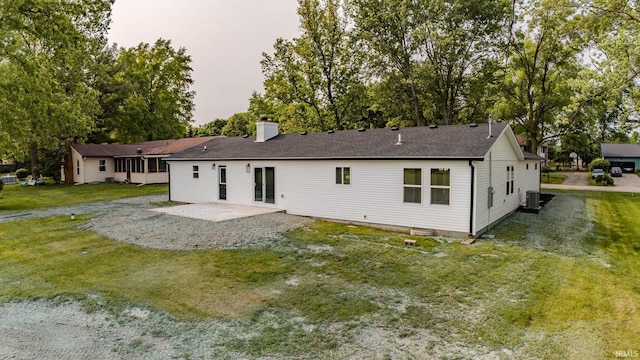 2135 Old Oak Dr, West Lafayette, IN 47906 - rear view of property featuring a patio, a chimney, a lawn, roof with shingles, and central AC