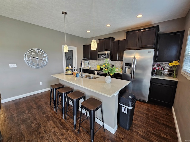 2659 Sea Biscuit Ln, Kokomo, IN 46901 - kitchen featuring stainless steel appliances, a sink, dark wood-style floors, a breakfast bar area, and recessed lighting
