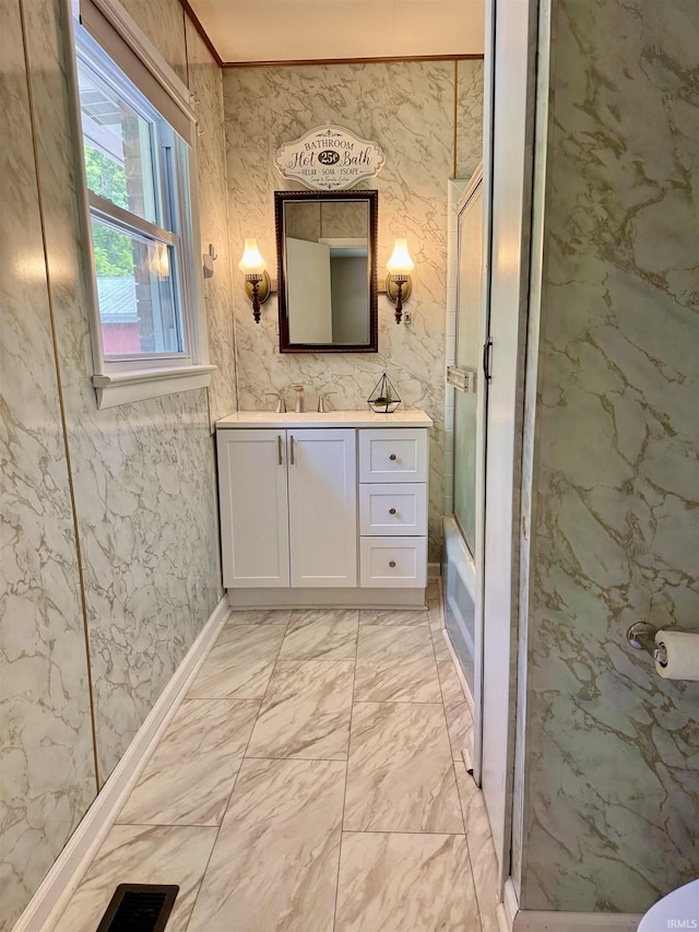 42 Center St, Avoca, IN 47420 - bathroom with vanity, marble look tiles, enclosed tub / shower combo, and ornamental molding