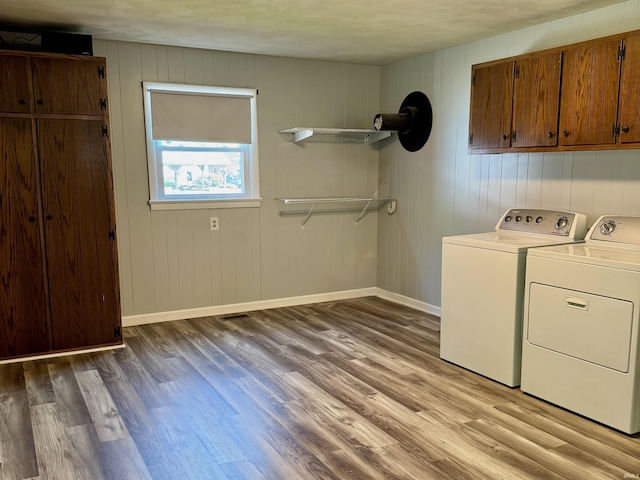 42 Center St, Avoca, IN 47420 - laundry area with cabinet space, washing machine and clothes dryer, light wood finished floors, and baseboards
