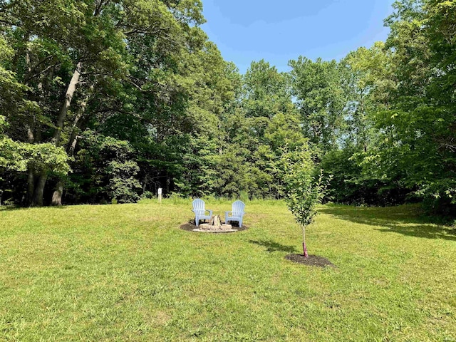 42 Center St, Avoca, IN 47420 - view of grassy yard featuring an outdoor fire pit