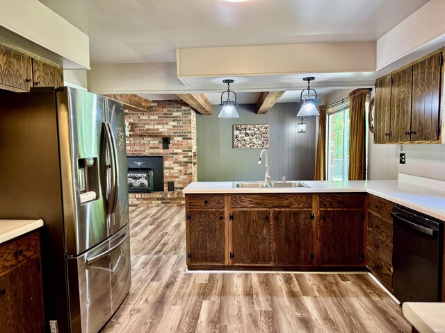 42 Center St, Avoca, IN 47420 - kitchen with stainless steel fridge with ice dispenser, a sink, dishwashing machine, light wood-style flooring, and light countertops