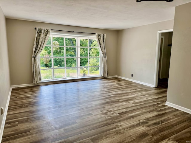 42 Center St, Avoca, IN 47420 - empty room featuring baseboards and dark wood-type flooring