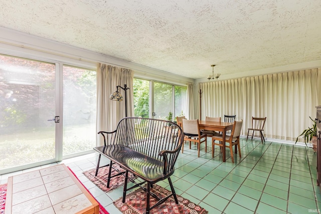 308 N Forest Ave, Muncie, IN 47304 - tiled dining room featuring a chandelier and a textured ceiling
