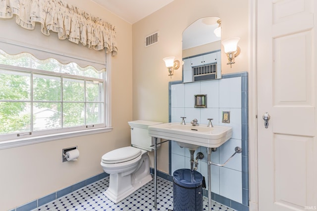 308 N Forest Ave, Muncie, IN 47304 - half bath featuring toilet, baseboards, tile patterned flooring, and a sink