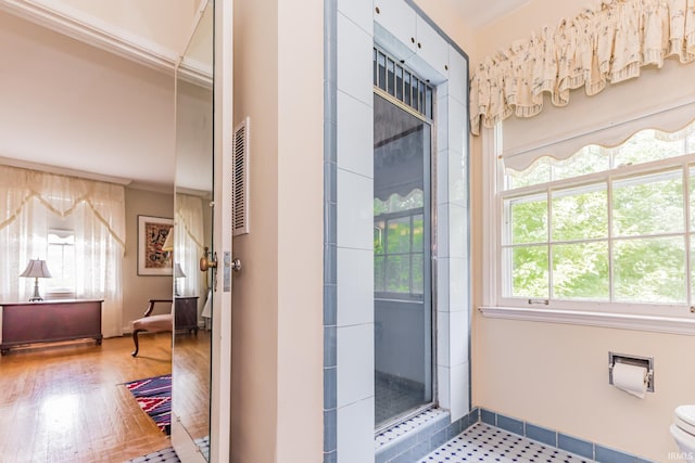 308 N Forest Ave, Muncie, IN 47304 - bathroom featuring healthy amount of natural light, ornamental molding, an enclosed shower, toilet, and wood finished floors