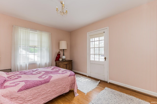 308 N Forest Ave, Muncie, IN 47304 - bedroom with wood finished floors, baseboards, a chandelier, and crown molding