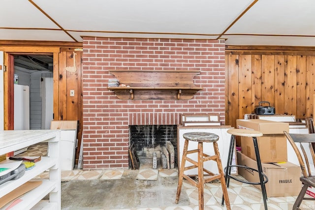 308 N Forest Ave, Muncie, IN 47304 - living area with a fireplace, wooden walls, and concrete floors
